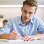 alumno que está redactando una carta formal en el examen escrito de C1 de Francés